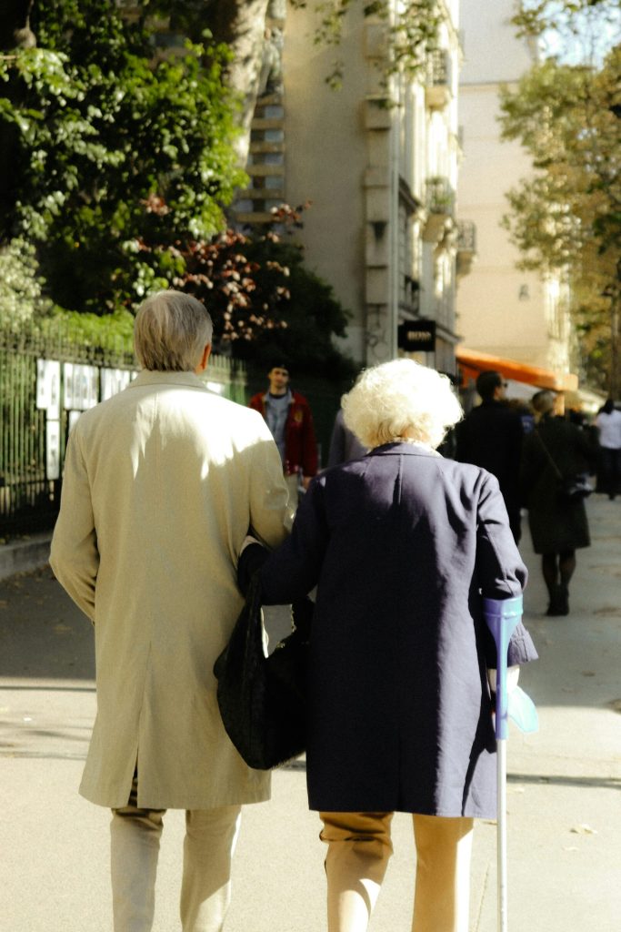 a couple of people walking down a sidewalk